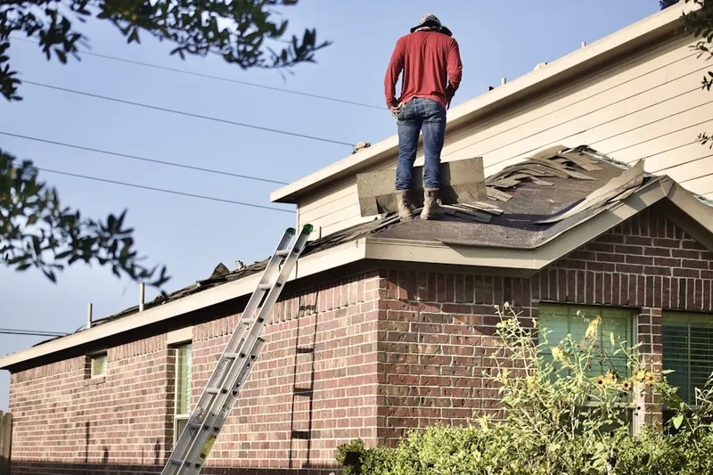 Professional roofer working on a residential roof in Latta Road